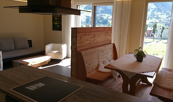 View from the kitchen (with extractor fan) to the dining table and couch, and also to the Matrei in Osttirol area
