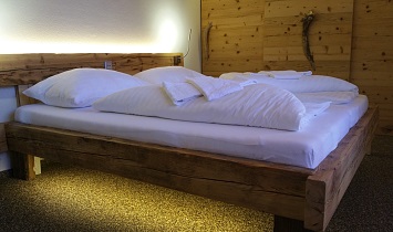 The floors in the Tradition apartments are made from stone elements, while the beds and chests are made from wood